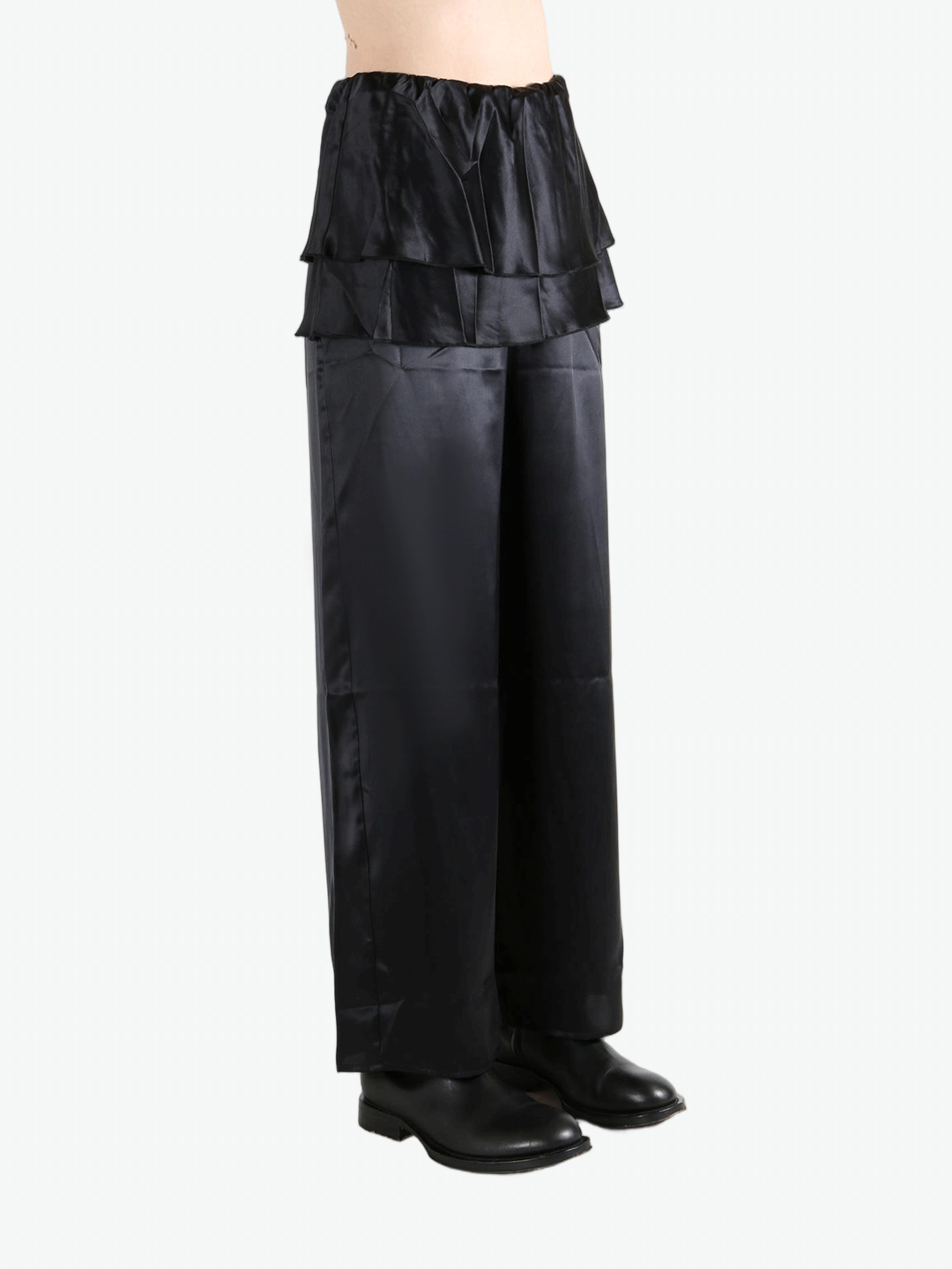 Black pants worn by a person, showing the pants' fit