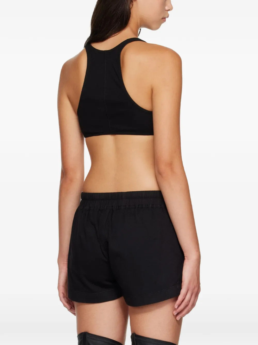 Black top worn by a person, showing the top fit
