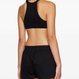 Black top worn by a person, showing the top fit