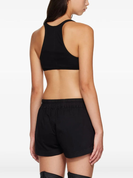 Black top worn by a person, showing the top fit
