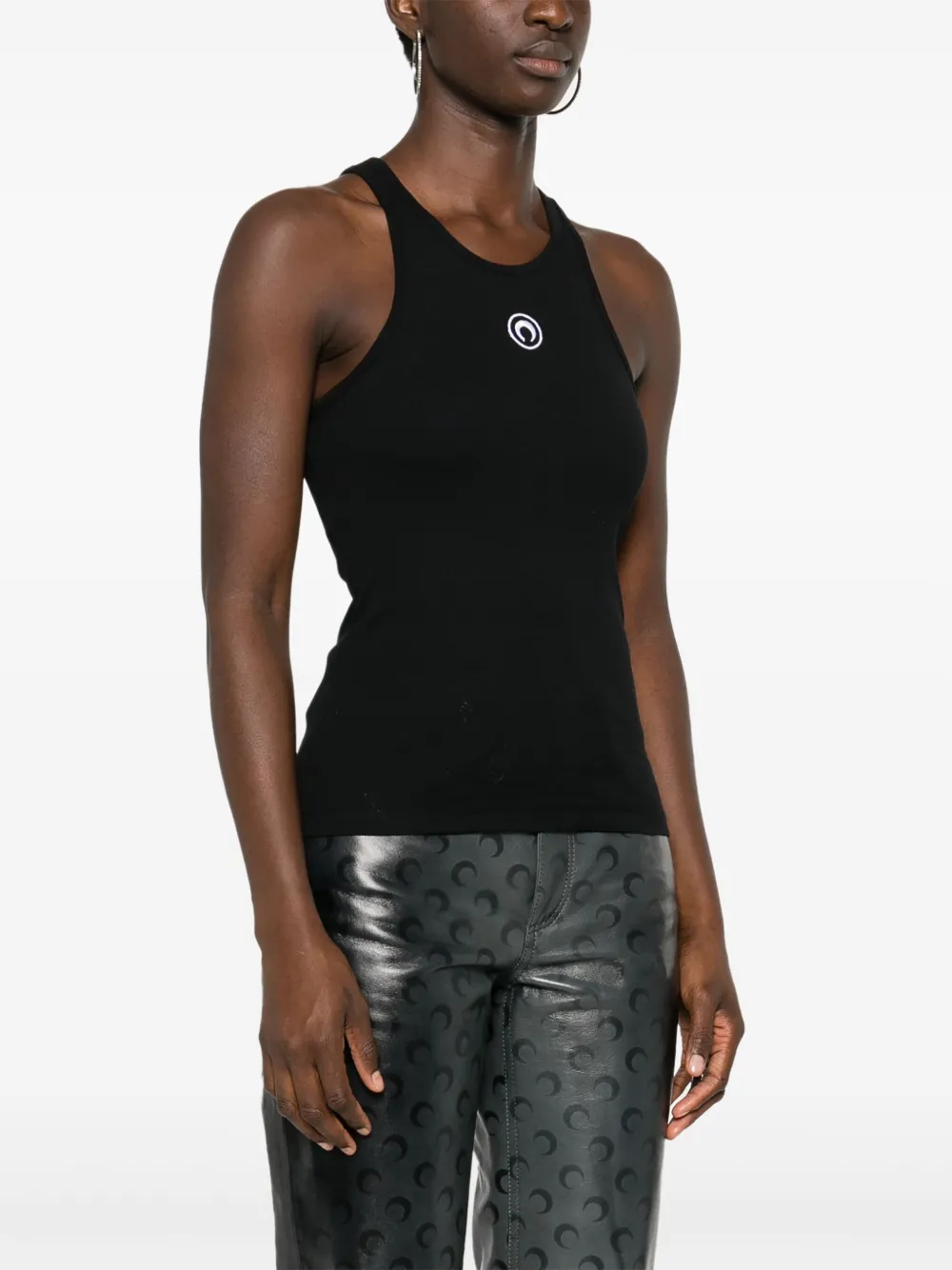 Black tops worn by a person, showing the tops' fit