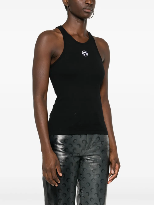 Black tops worn by a person, showing the tops' fit