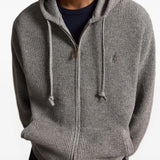 Grey knitwear worn by a person, showing the knitwear fit