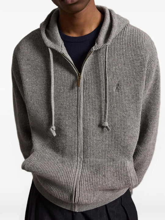 Grey knitwear worn by a person, showing the knitwear fit