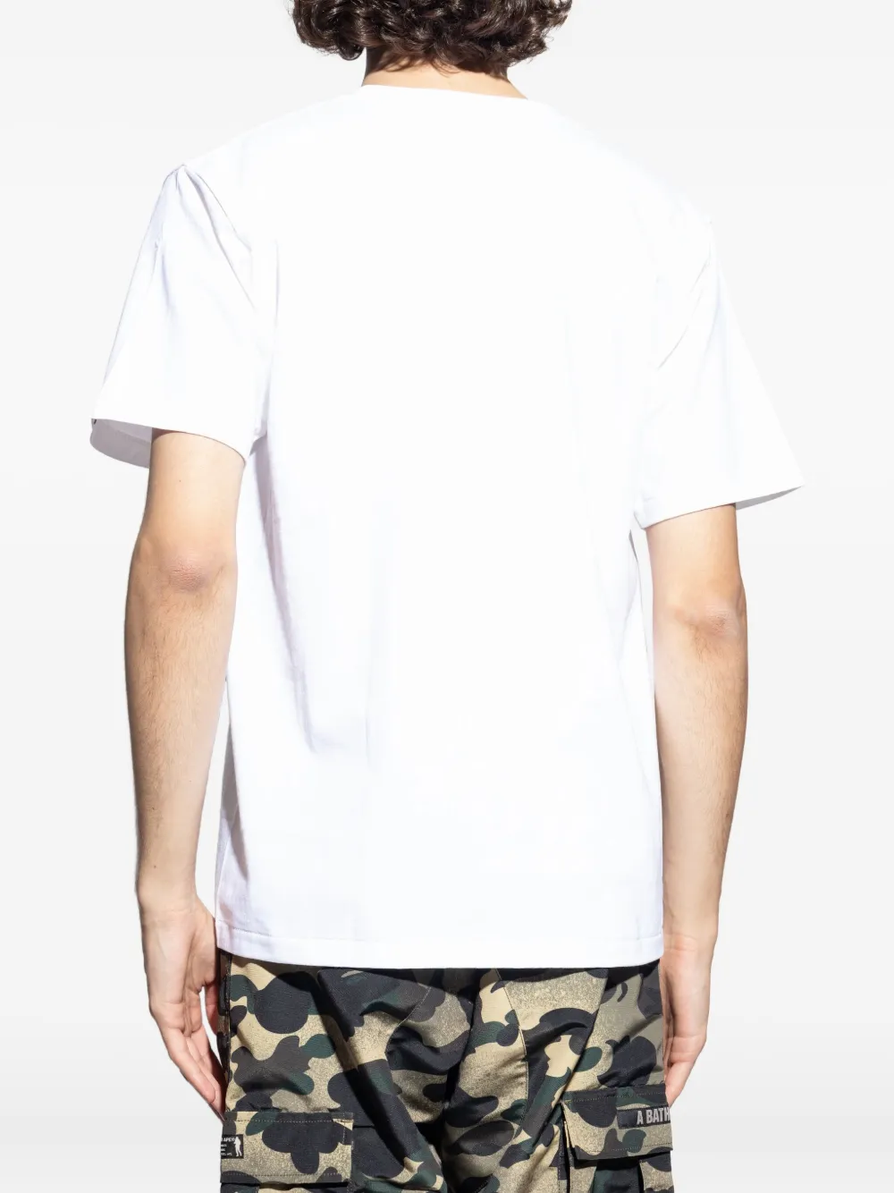 Whitet-shirt worn by a person, showing the shirt's fit