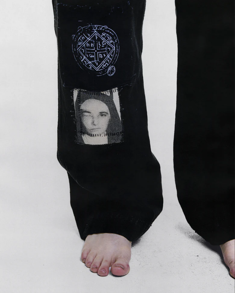 Black pants worn by a person, showing the pants fit