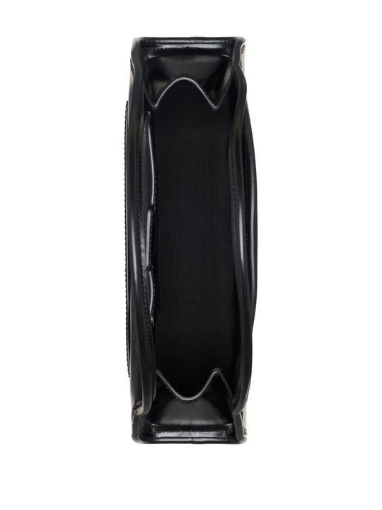 Close up of black bag, showing texture of the leather  fabric