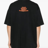 Black t-shirts worn by a person, showing the t-shirts fit