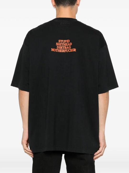 Black t-shirts worn by a person, showing the t-shirts fit