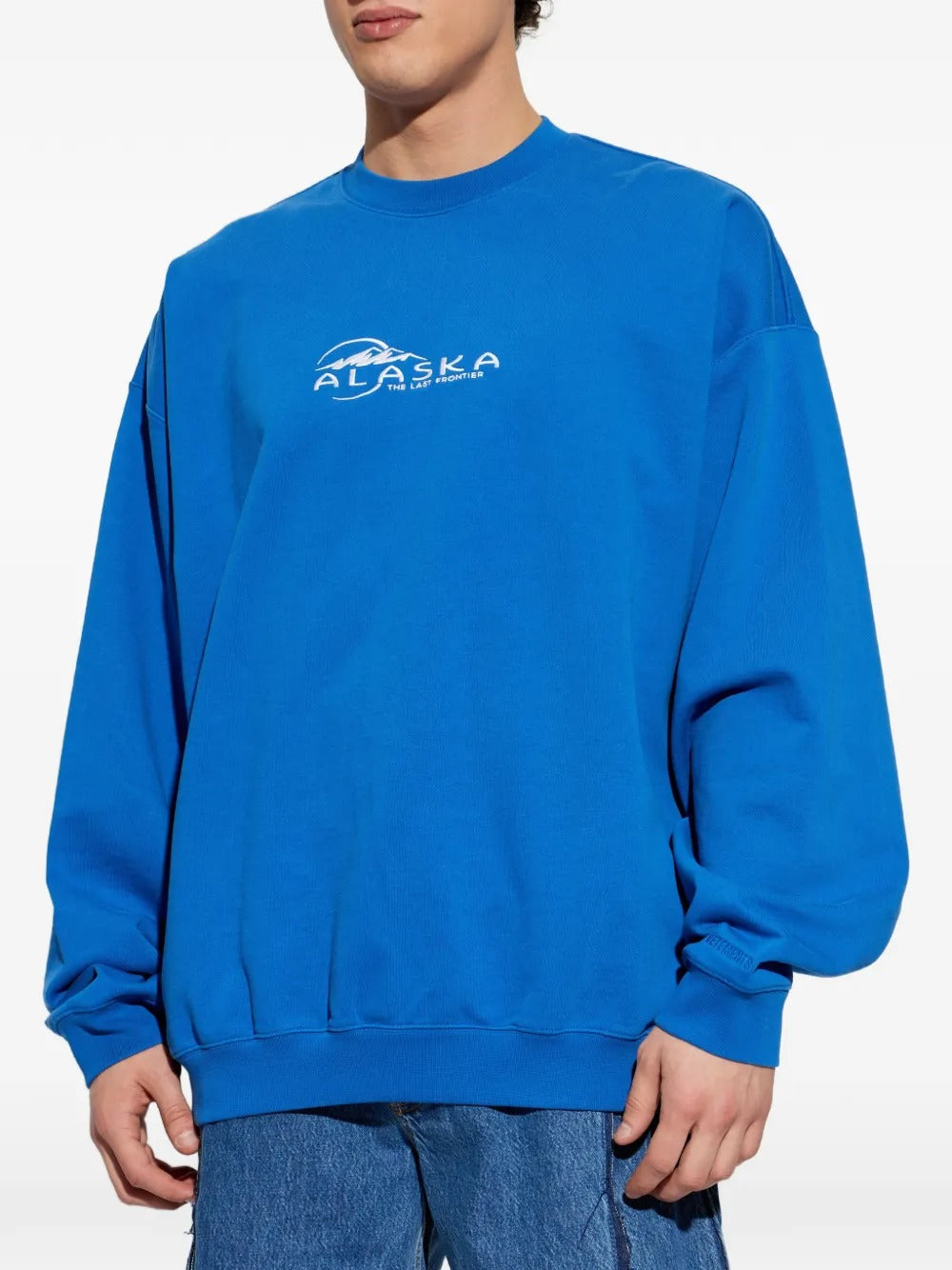blue sweatshirt worn by a person, showing the sweatshirt fit