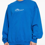 blue sweatshirt worn by a person, showing the sweatshirt fit