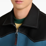 Close up of blue jacket, showing texture of the Cotton fabric