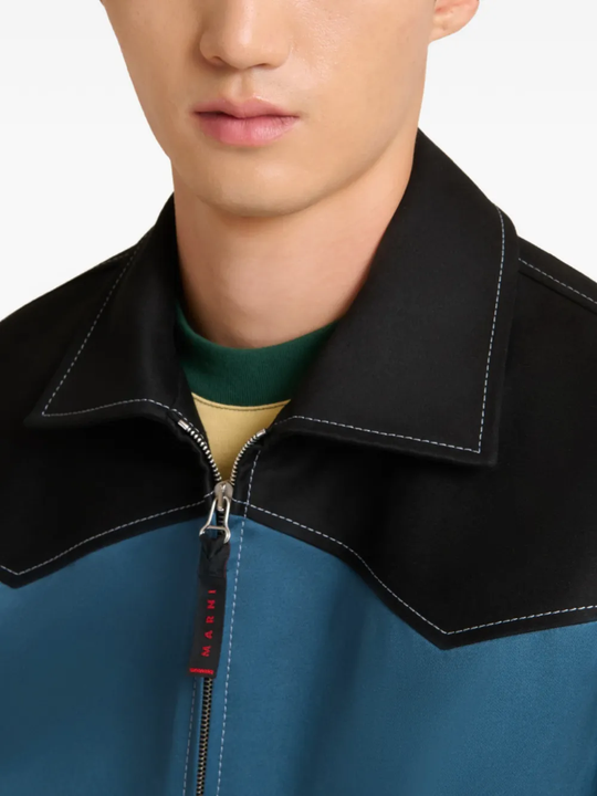 Close up of blue jacket, showing texture of the Cotton fabric