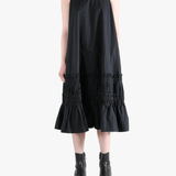 Black dress worn by a person, showing the dress's fit