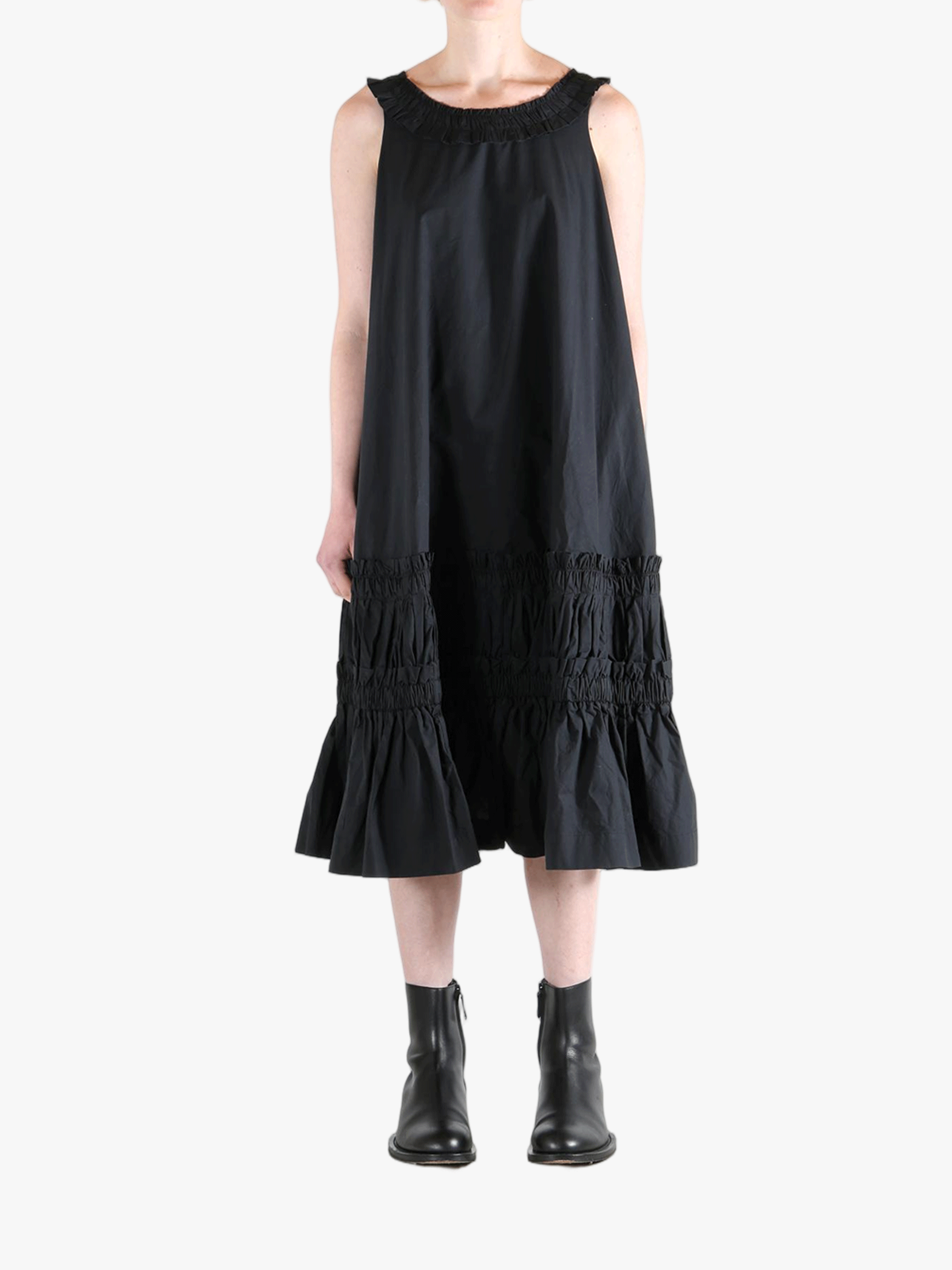 Black dress worn by a person, showing the dress's fit