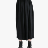Black skirt worn by a person,showing the skirt fit