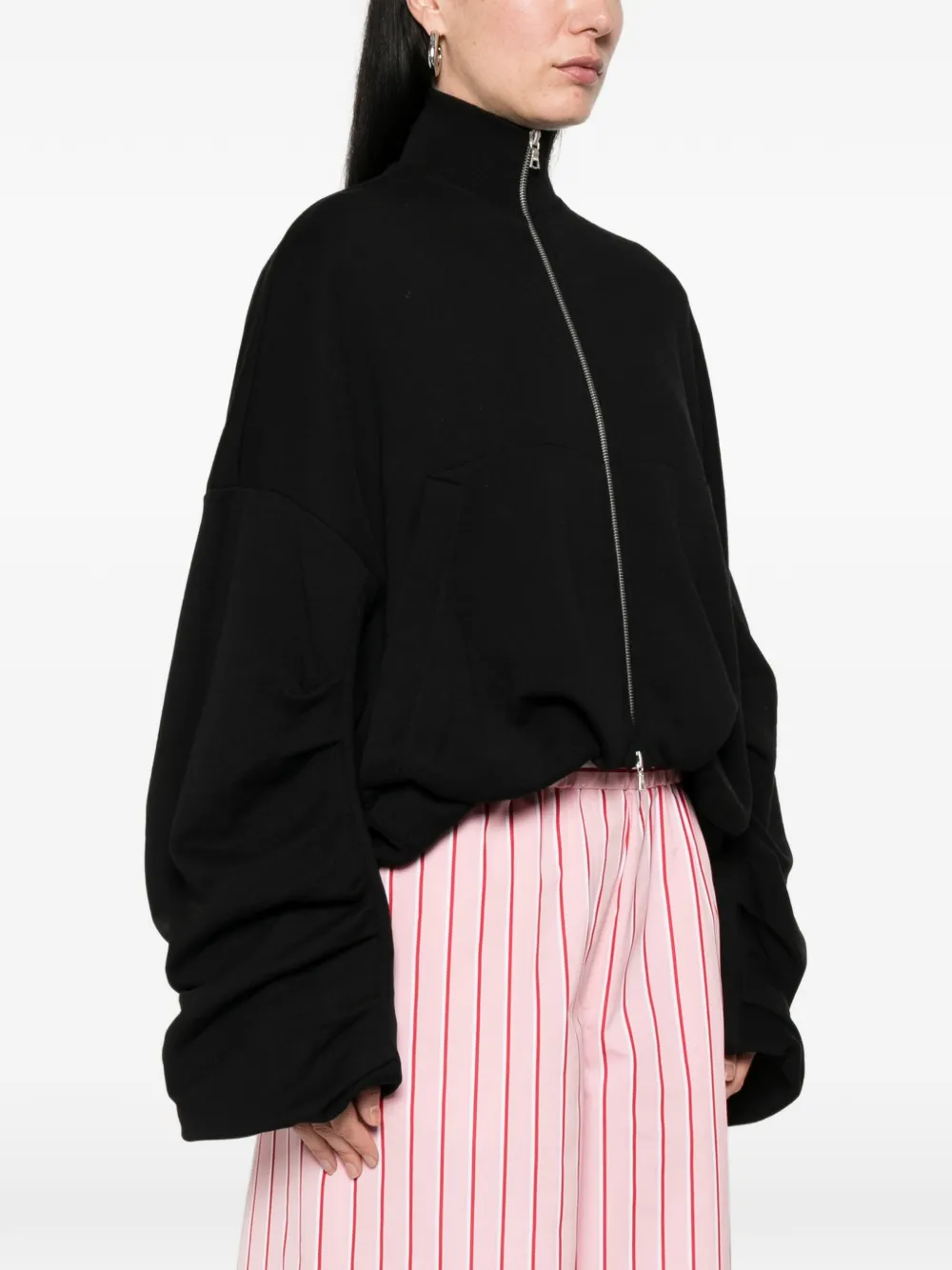 Black jacket worn by a person, showing the jacket's fit