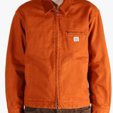 Orange jacket worn by a person, showing the jacket fit