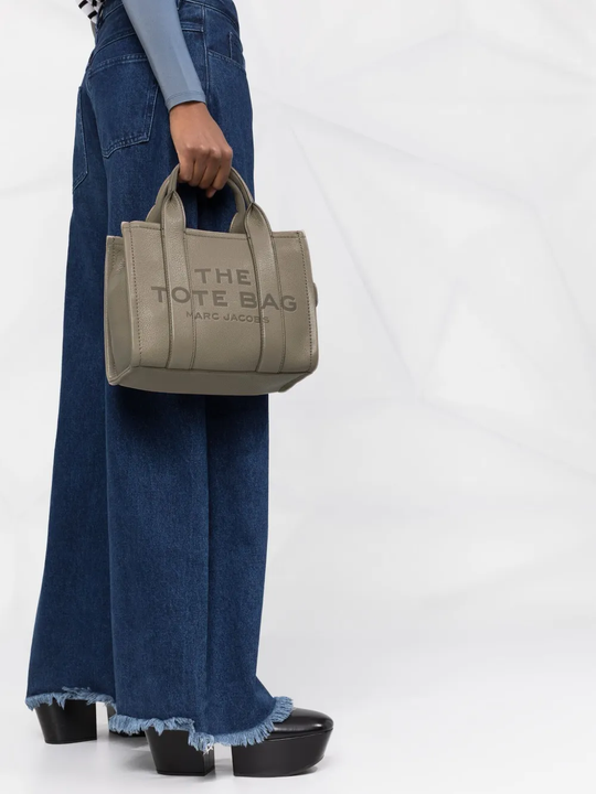 Tan bag worn by a person, showing the bag's fit