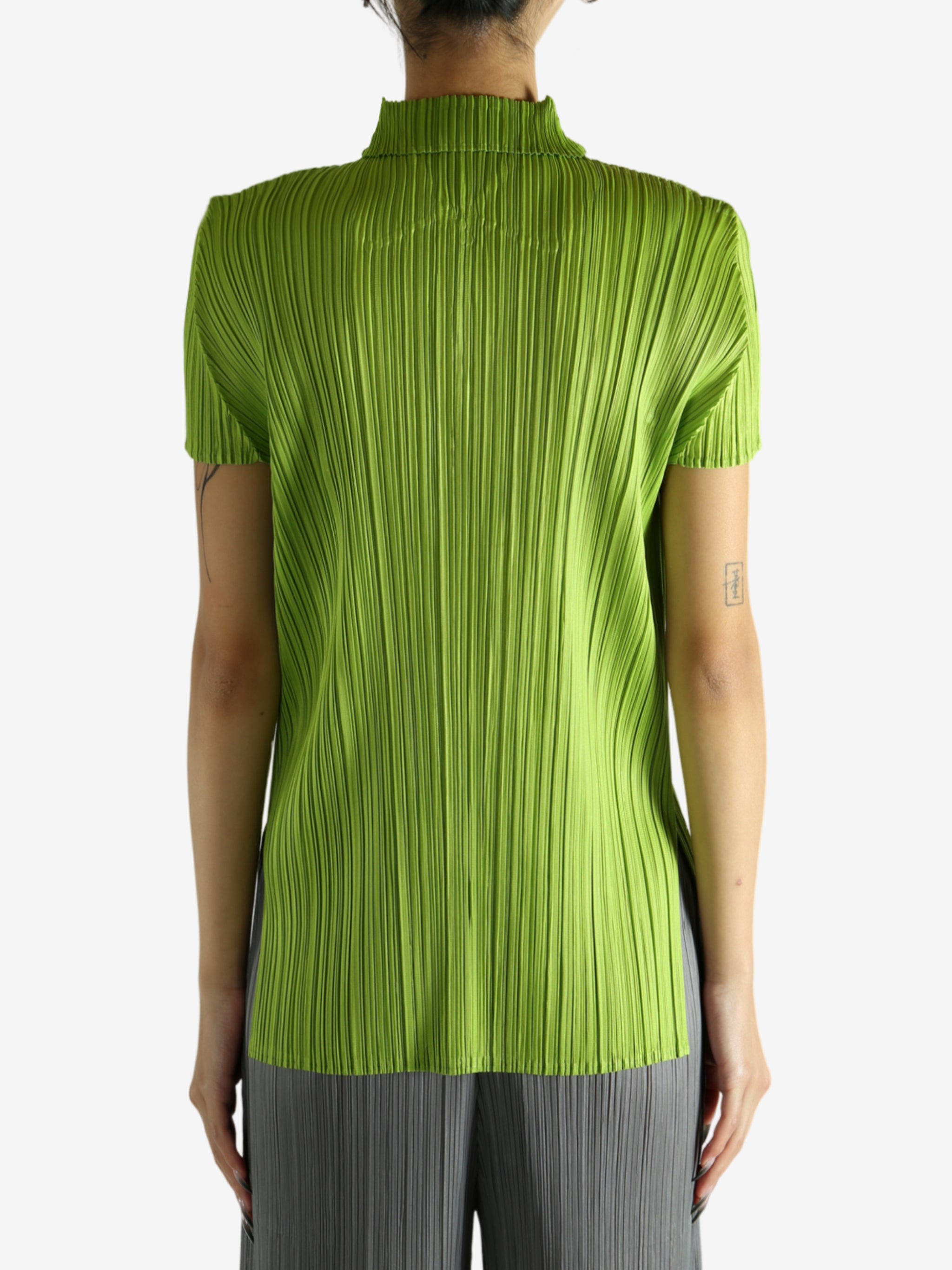 Green shirt worn by a person, showing the shirt's fit