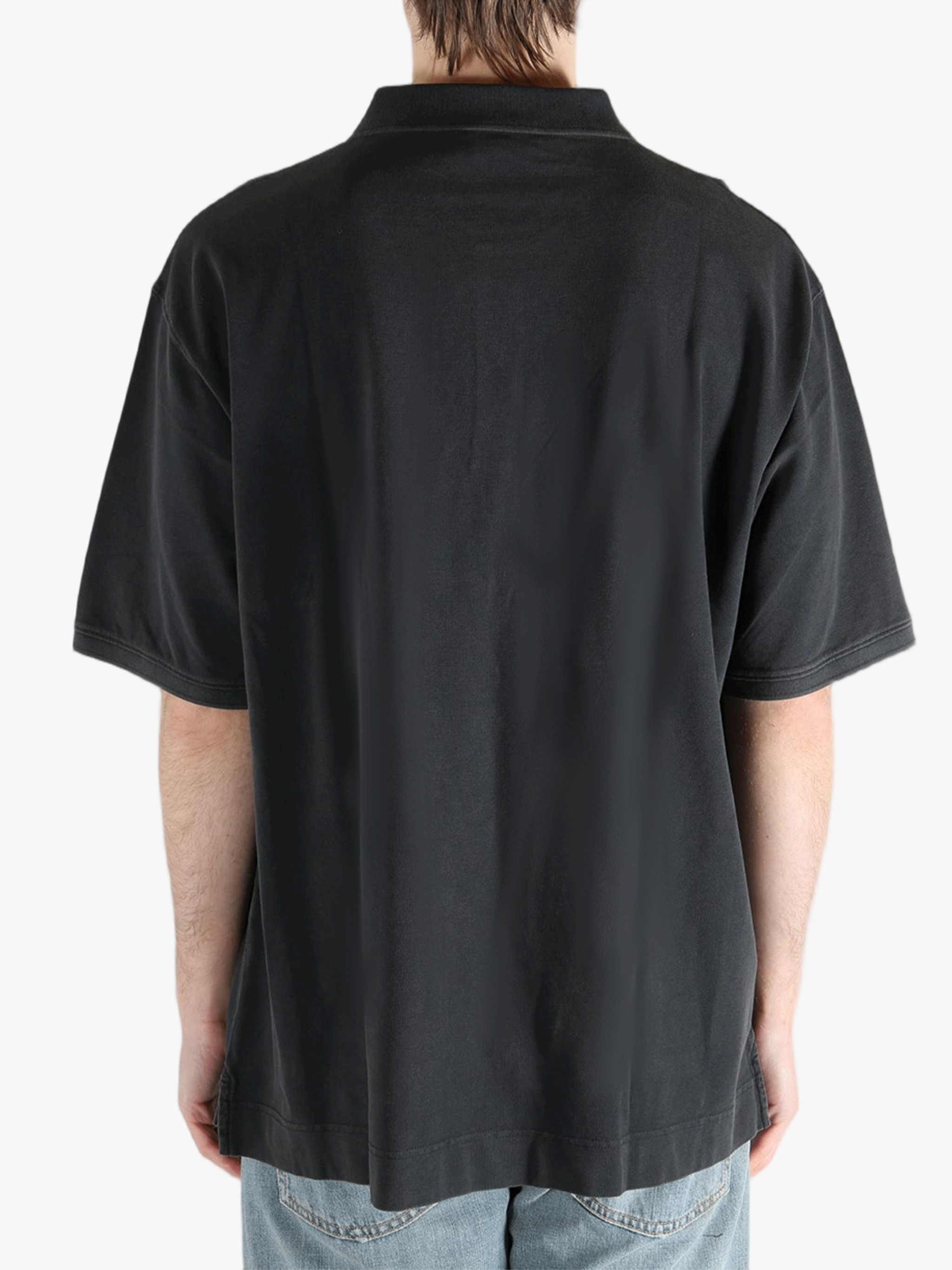 Black t-shirt worn by a person, showing the cotton fit