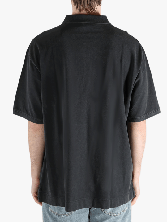 Black t-shirt worn by a person, showing the cotton fit