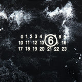 Close-up of black t-shirt, showing texture of the cotton blend fabirc