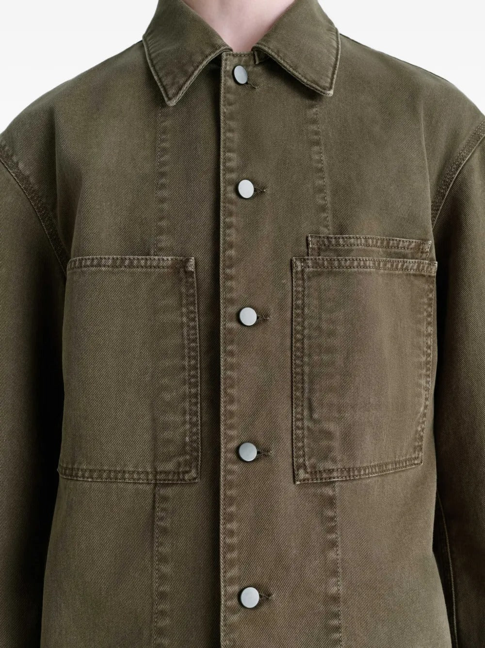 Close up of the green shirt, showing texture of the cotton fabric