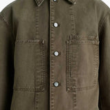 Close up of the green shirt, showing texture of the cotton fabric