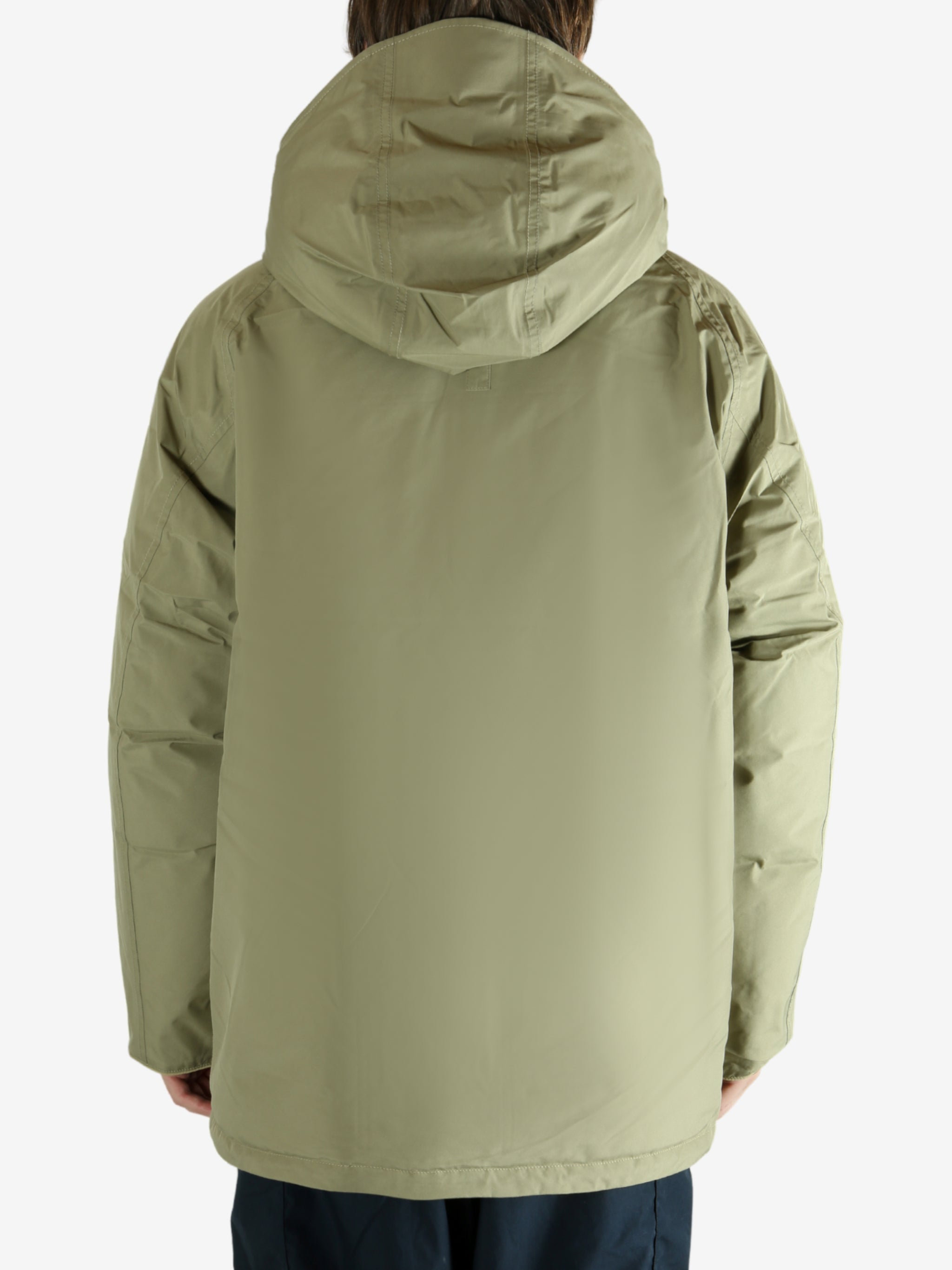 Green jacket worn by a person, showing the jacket's fit