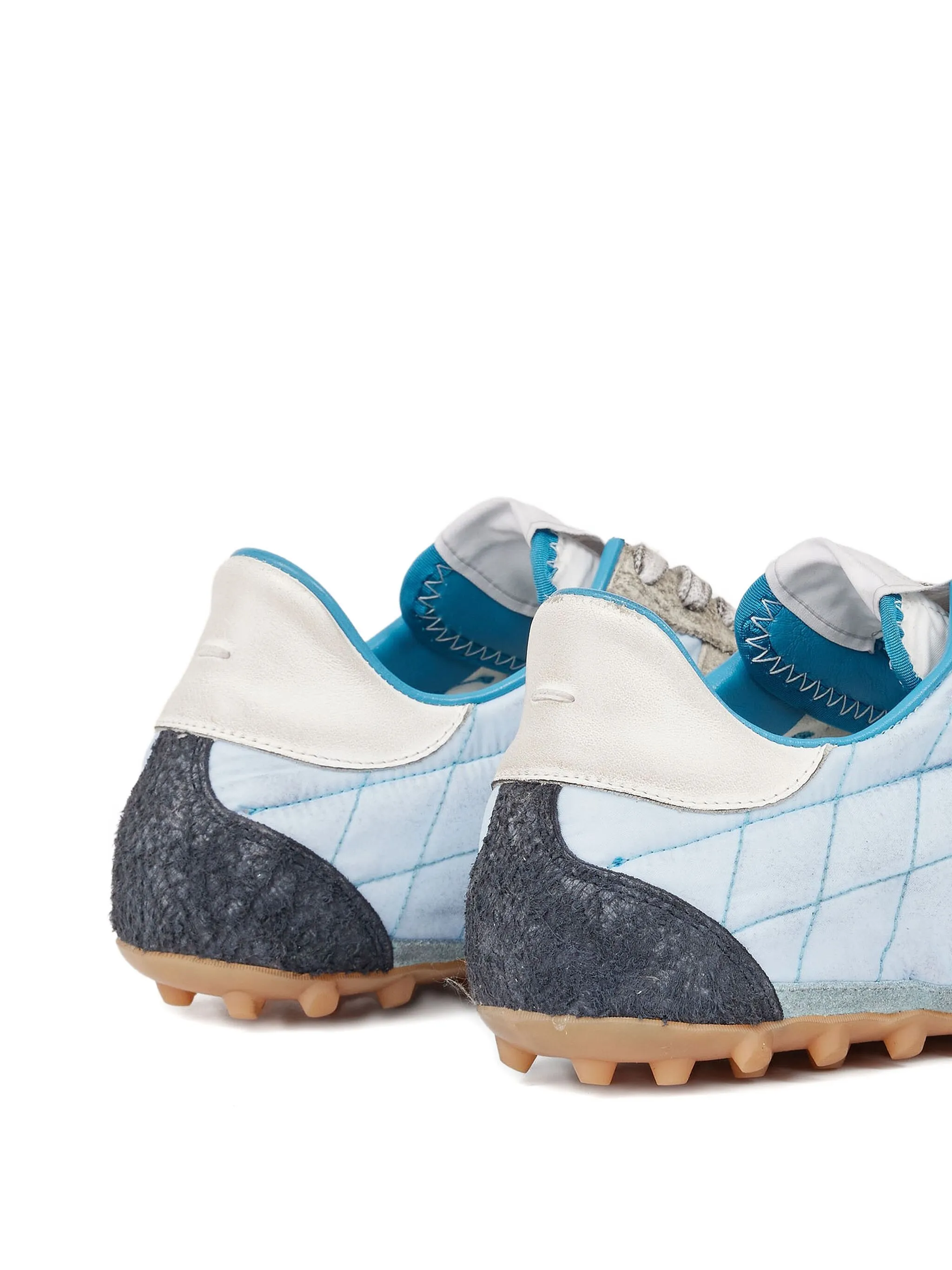 Close up of blue shoes, showing texture of the polyester fabric