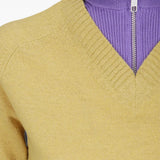 Yellow knitwear worn by a person, showing the knitwear fit