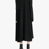 Black dress worn by a person, showing the dress' fit