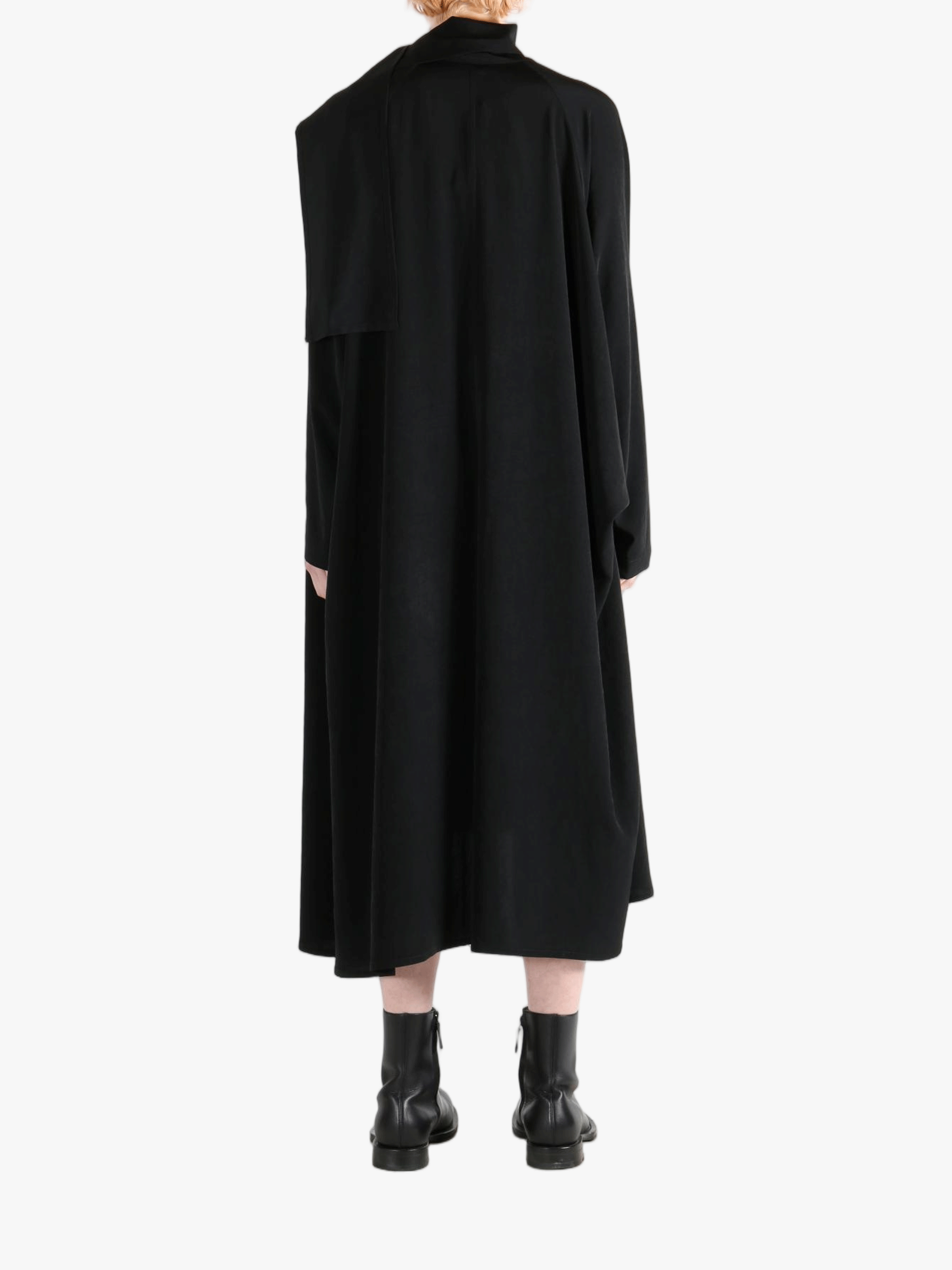 Black dress worn by a person, showing the dress' fit