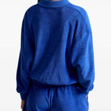 Blue top worn by a person, showing the top's fit
