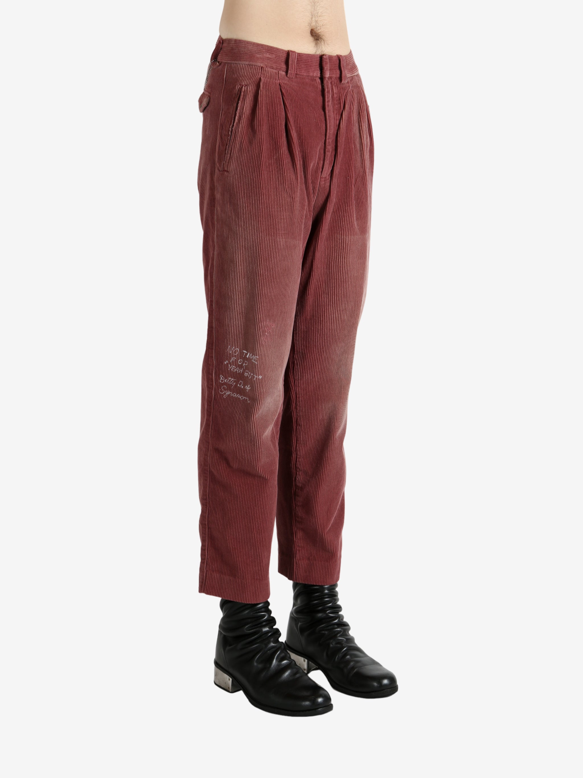 Burgundy pants, worn by a person, showing the pants's fit