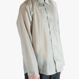 Grey shirt worn by a person, showing the shirt's fit