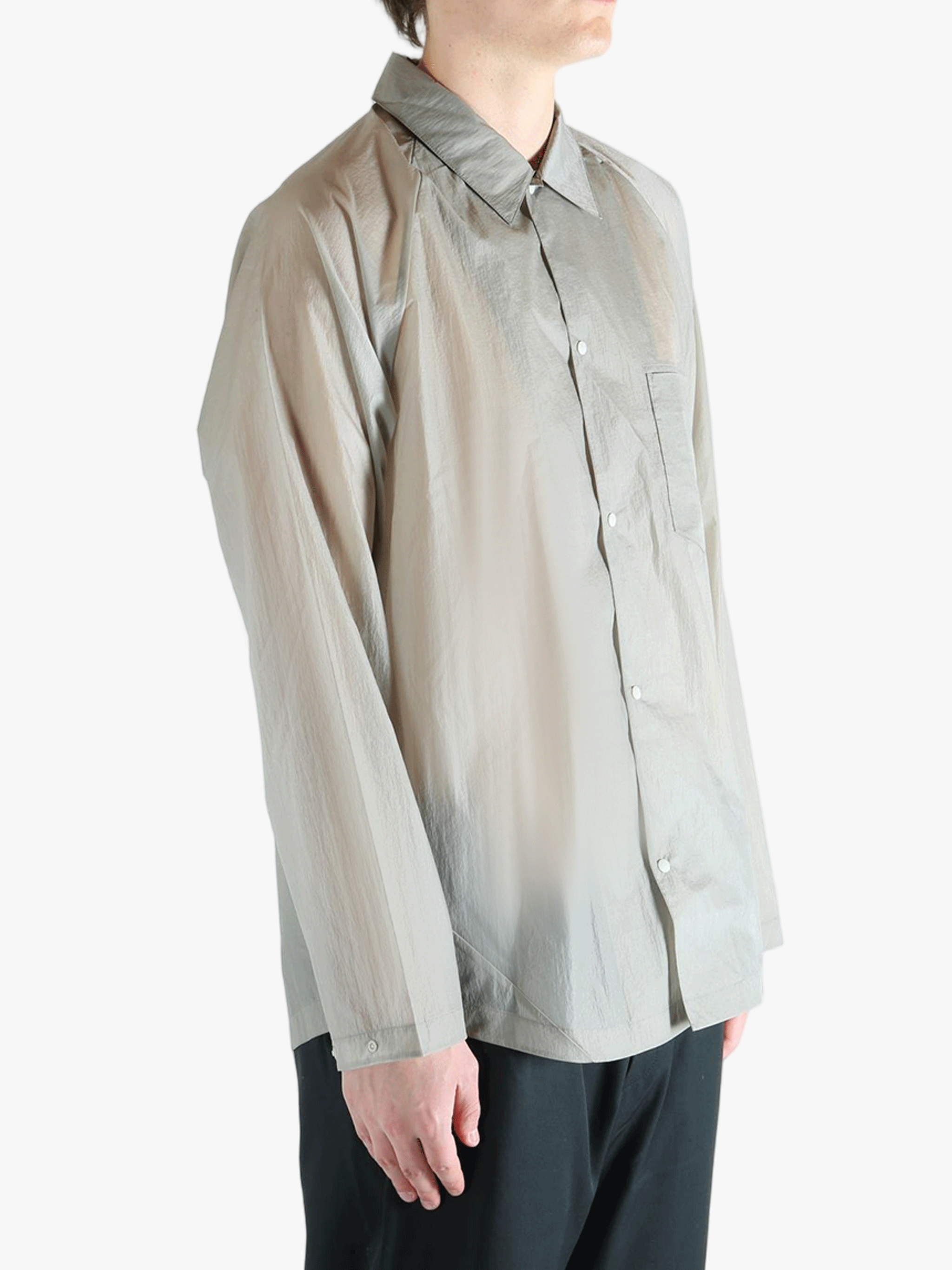 Grey shirt worn by a person, showing the shirt's fit