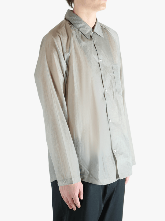 Grey shirt worn by a person, showing the shirt's fit