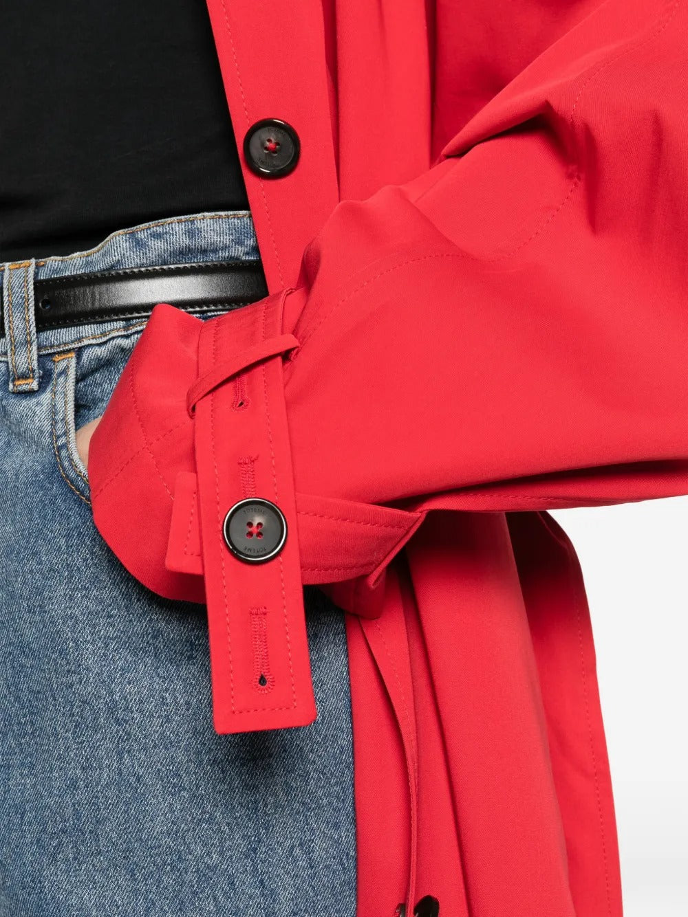 Close up of red coats, showing texture of the cotton organic fabric