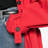 Close up of red coats, showing texture of the cotton organic fabric