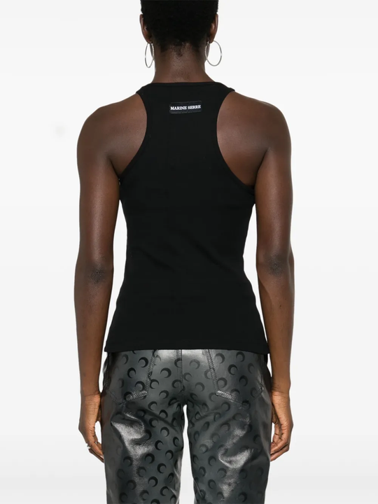 Black tops worn by a person, showing the tops' fit