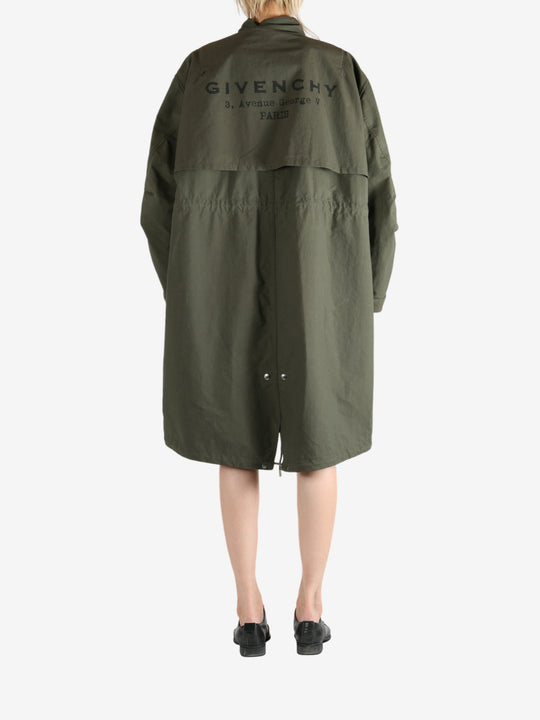 Green coat worn by a person, showing the coat fit