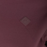 Close up of Burgundy jacket, showing texture of the 70% recycled polyester/ 30% elastane made in fabric
