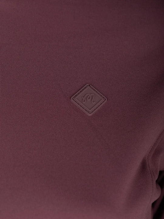 Close up of Burgundy jacket, showing texture of the 70% recycled polyester/ 30% elastane made in fabric