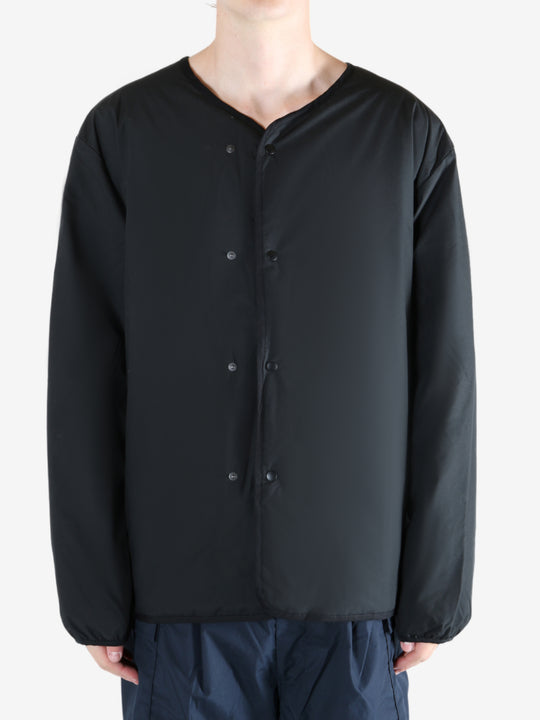 Black cardigan worn by a person, showing the cardigan's fit