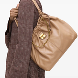 Brown bags worn by a person, showing the bags fit