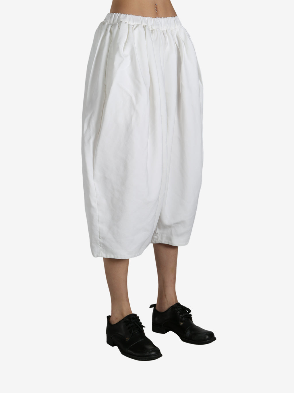 White pants worn by a person, showing the pants fit