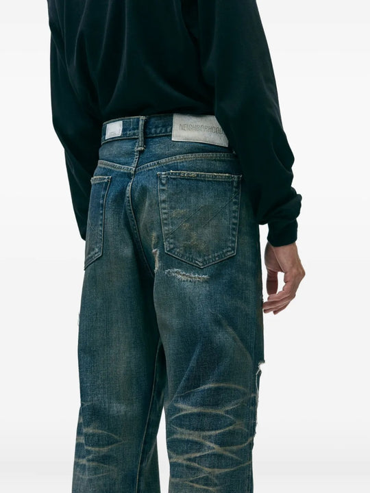 Blue pants worn by a person, showing the pants's fit