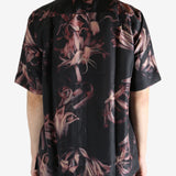 Black shirt worn by a person, showing the shirt's fit